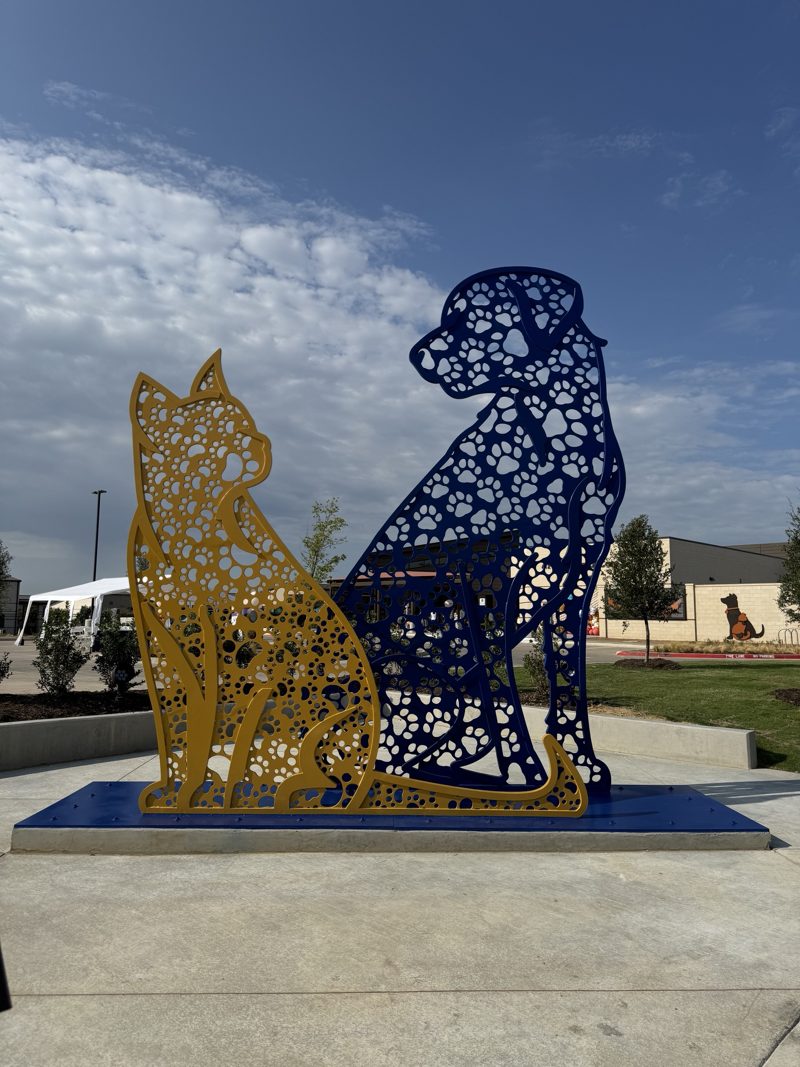 Paw in Paw, a 16-foot blue and gold metal cat and dog sculpture in Mansfield, Texas