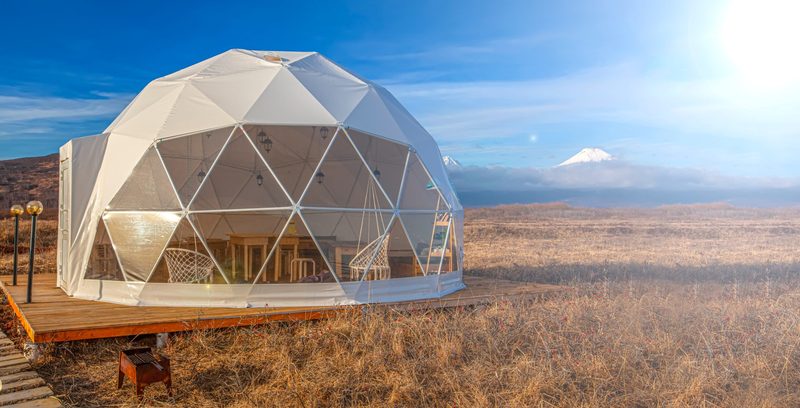 Clear-panel glamping dome on a timber deck