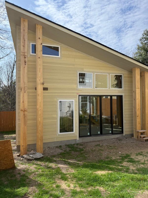 Backyard accessory dwelling unit with a shed roof and sliding glass doors in Austin, Texas