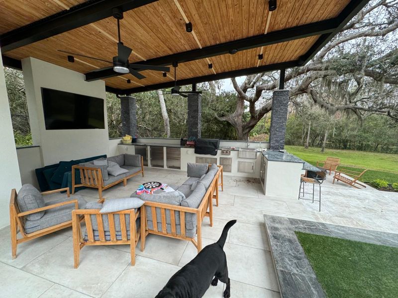 Covered outdoor living room with a wood ceiling and steel beams in Tampa, Florida