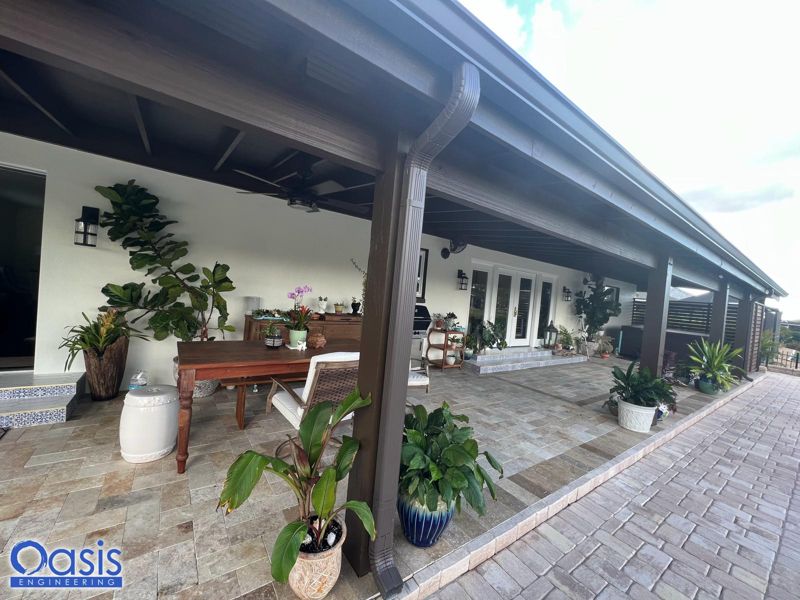 Long covered lanai addition with a dark beam and paver floor in Tampa, Florida