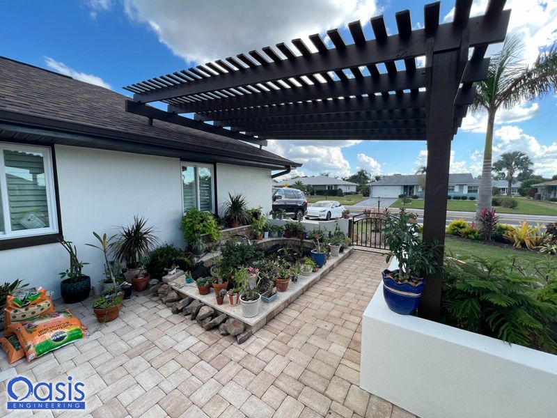 Dark aluminum lean-to pergola over a paver patio in Tampa, Florida