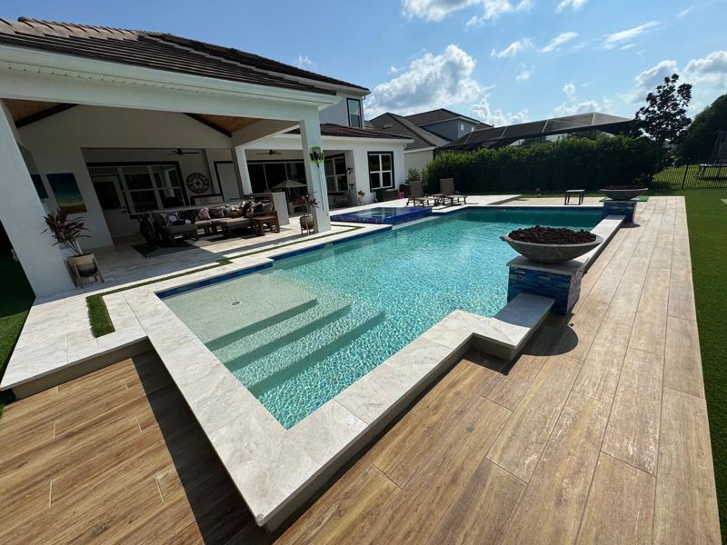 Covered lanai and pool with a wood-look deck in Odessa, Florida
