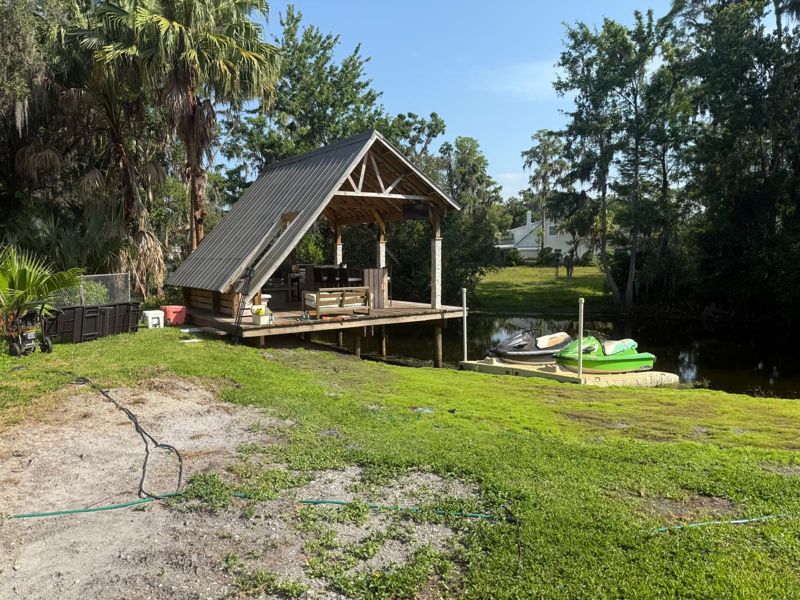 Timber A-frame pavilion on a waterfront lot with a dock in Tampa, Florida