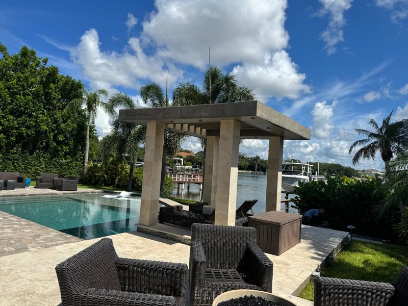 Stone-column cabana beside a pool on the water in St. Petersburg, Florida