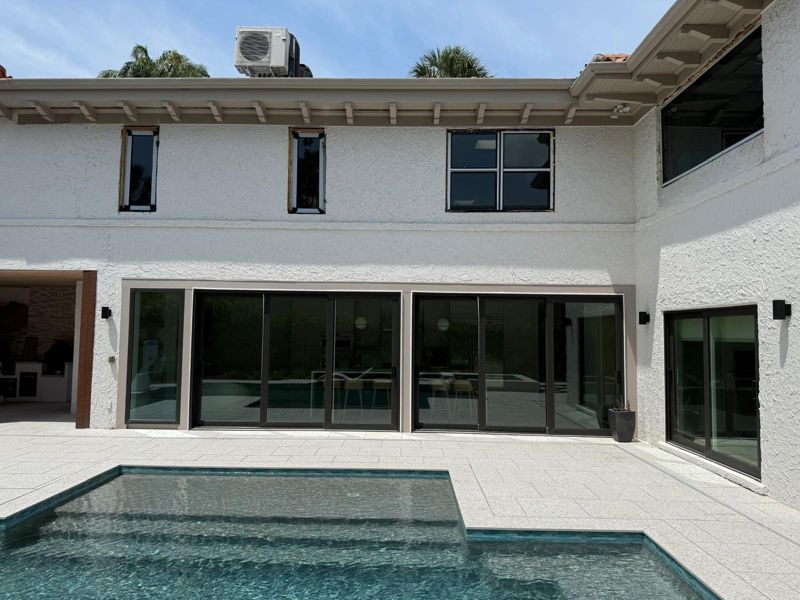 Wall of large sliding glass doors facing a pool in Tampa, Florida