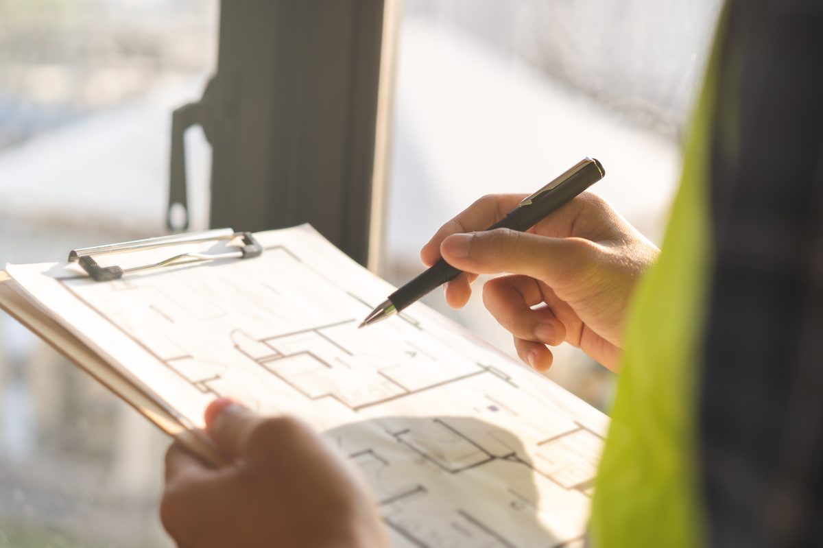 Engineer reviewing drawings with a pen