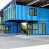 Modern blue cutting-edge shipping container construction office building.