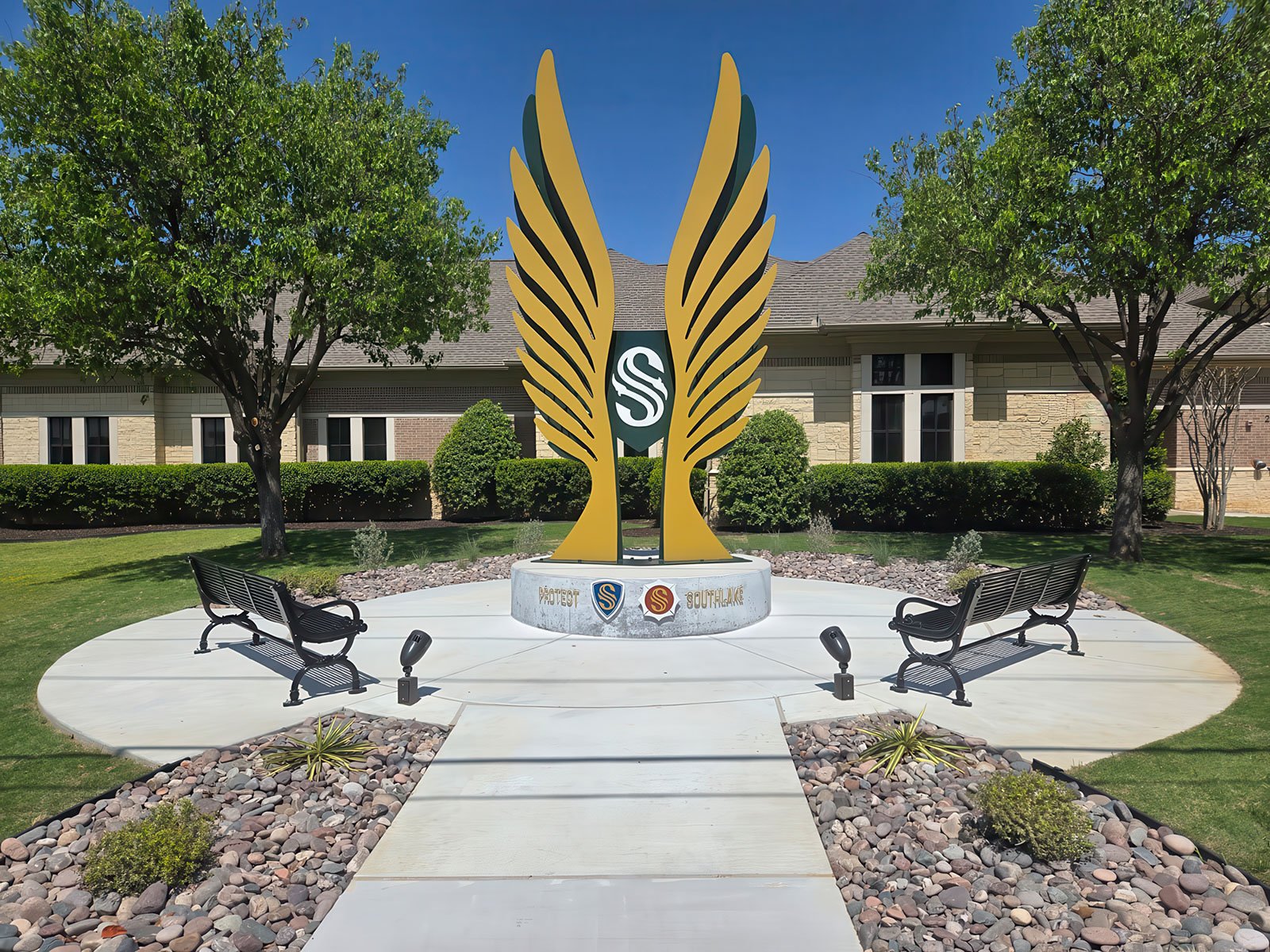 he central shield detail of “Under Our Wings,” featuring Southlake’s emblematic “S” surrounded by elliptical rings that represent the ripple effect of safety throughout the community.